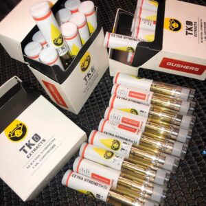 Premium TKO vape cart close-up showing gold cannabis oil